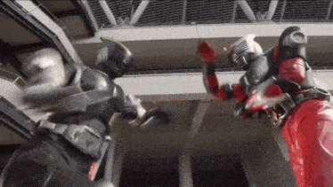 two action figures are fighting each other in a building