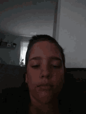 a man is laying on a couch with his eyes closed .