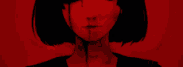 a close up of a girl 's face with blood on it against a red background .