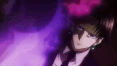 a man in a suit and tie is standing in a dark room with a purple background .