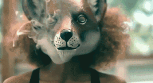 a woman wearing a mask of a fox smoking a cigarette