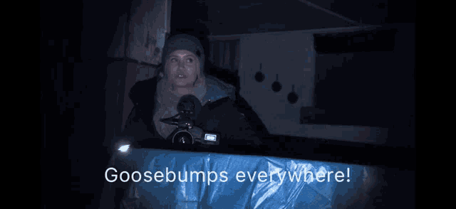 a woman holding a camera with the words goosebumps everywhere on the bottom