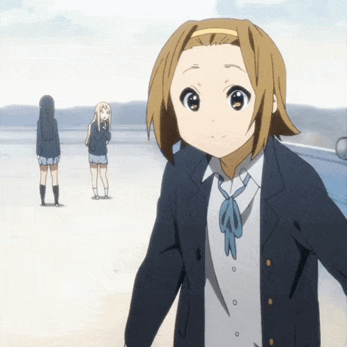 a girl in a school uniform with a blue bow tie