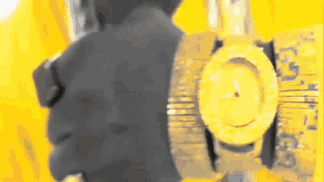 a close up of a person 's face with a watch on their wrist