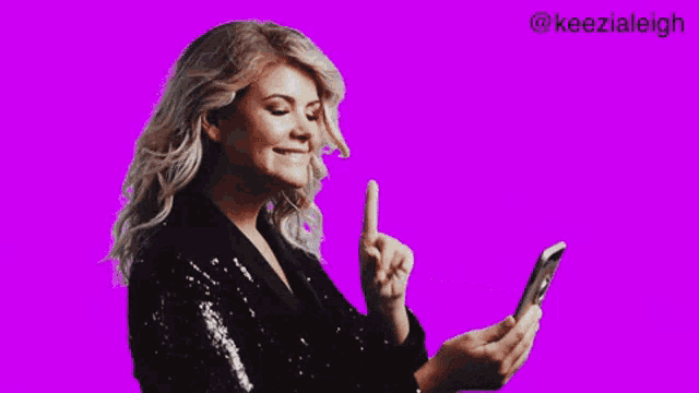 a woman holding a bunch of money and a phone