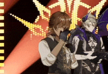 a man and a woman are standing on a stage in front of a spotlight .
