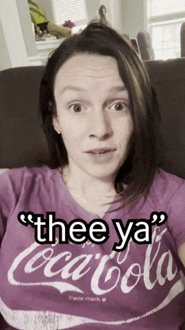 a woman wearing a purple coca cola t-shirt