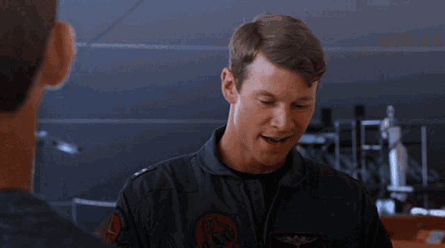 a man in a military uniform has a patch on his jacket that says us navy