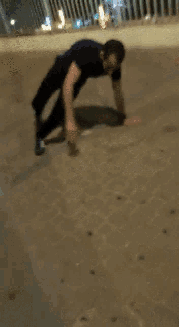 a man is doing push ups on the sidewalk