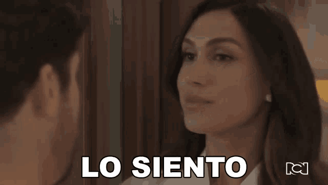 a man and a woman are looking at each other and the woman says lo siento in spanish