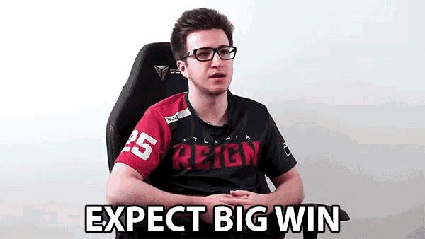 a man wearing a reign shirt is sitting in a chair and saying expect big win