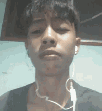 a young man is wearing headphones around his neck .