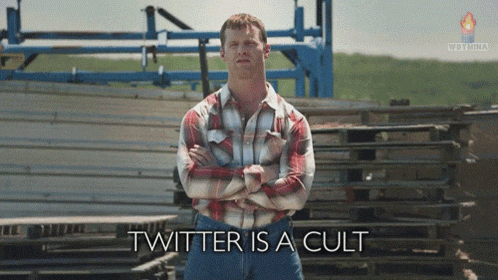 a man in a plaid shirt stands in front of a fence with the words twitter is a cult written below him