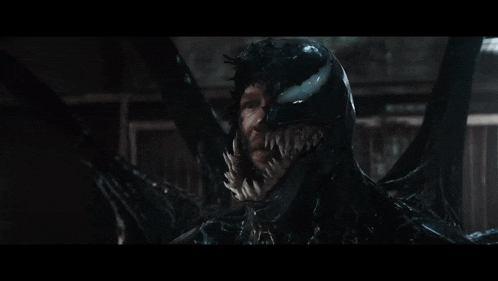 a close up of venom 's face with a lot of teeth .