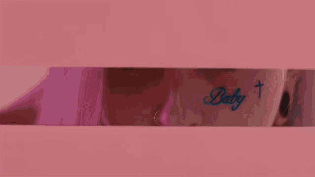 a close up of a woman 's face with a tattoo that says baby
