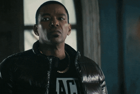 a man wearing a jacket and a shirt that says ac on it