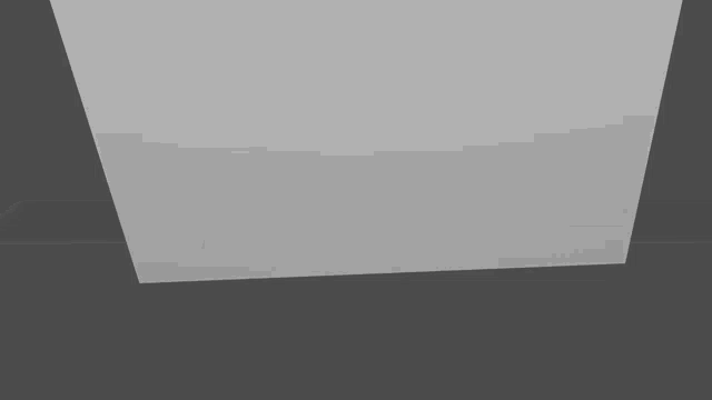 a white square is sitting on a gray surface on a gray background .