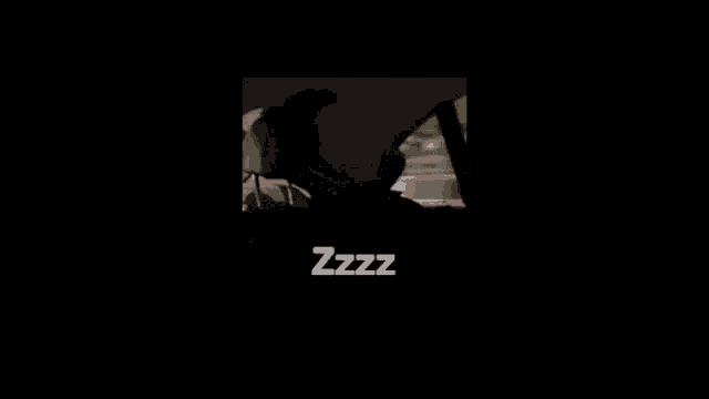 a man is talking on a cell phone in a dark room with the words zzz written on the bottom .
