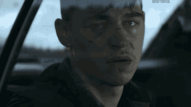 a close up of a man sitting in a car with a black eye .