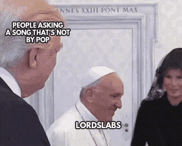 a man and a woman are standing next to each other and talking to a pope .