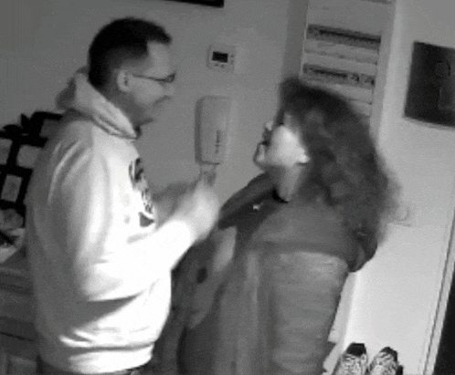 a man and a woman are fighting in a room