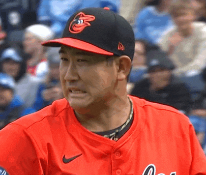 a baseball player wearing a red jersey and a black hat with the orioles logo on it