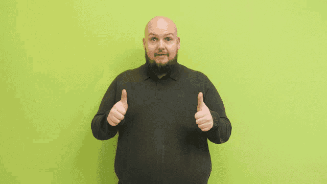 a bald man with a beard is giving a thumbs up