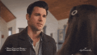 a man and a woman are looking at each other in a hallmark ad