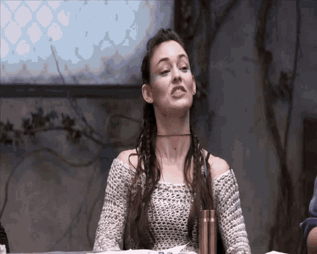 a woman sitting at a table with her mouth open