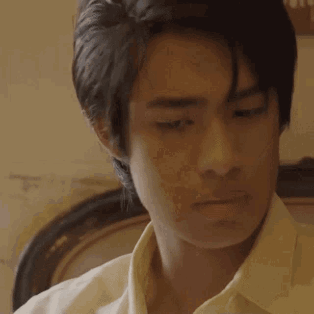 a close up of a young man 's face with his eyes closed .