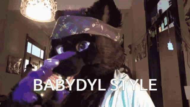 a cat wearing a headband with the words babydyl style written below it