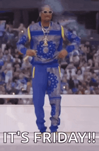 snoop dogg is dancing in front of a crowd and the words `` it 's friday '' are written on the screen .