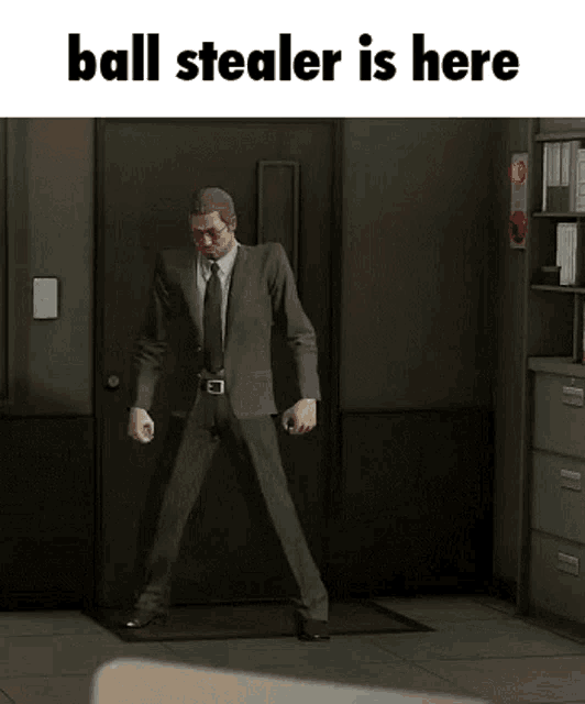 a man in a suit and tie is standing in front of a door with the words ball stealer is here on the bottom .