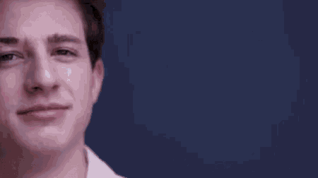 a close up of a young man 's face with a smile on it .