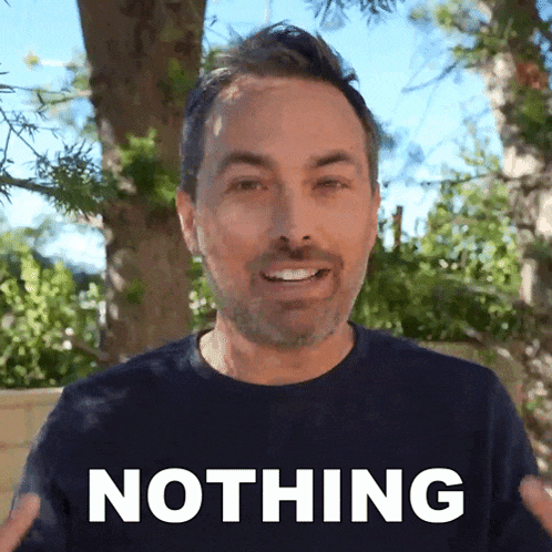 a man in a blue shirt says nothing in front of a tree
