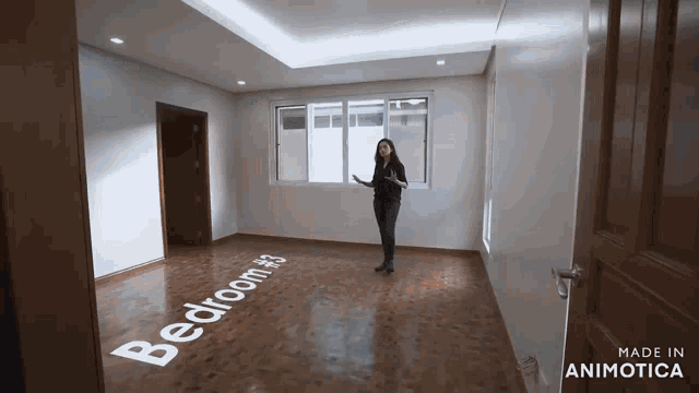 a woman is standing in an empty bedroom with the words bedroom # 3 written on the floor