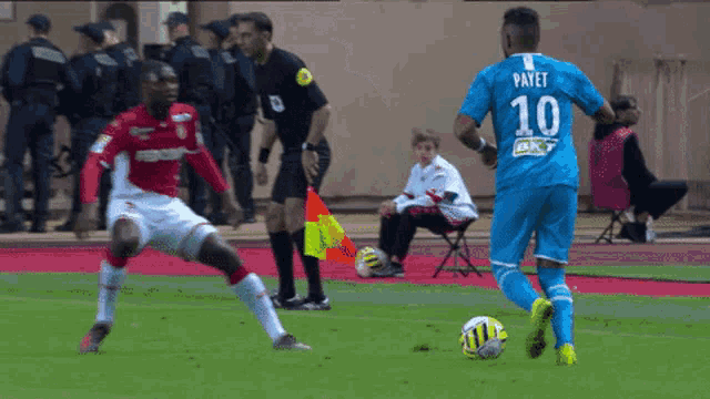 a soccer player with the number 10 on his jersey kicks the ball