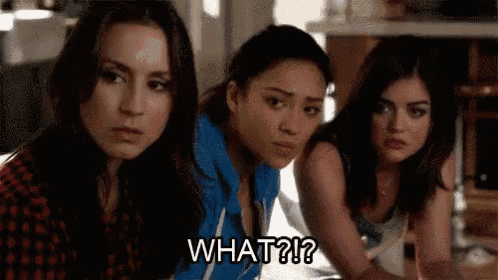 three women are sitting next to each other on a couch and one of them is saying `` what ? ''