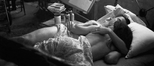 a man and a woman are laying on a bed .