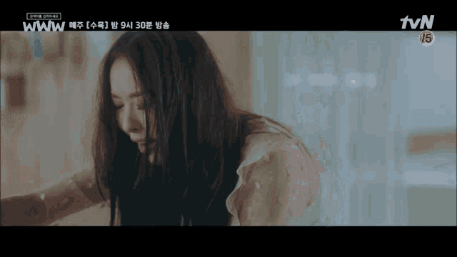 a woman is sitting in front of a tv screen that says tvn