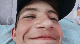 a close up of a man 's face wearing a baseball cap