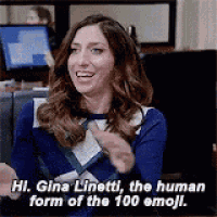 a woman in a blue sweater is sitting in front of a computer and talking .