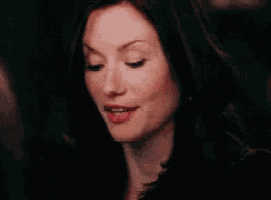 a close up of a woman 's face with a smile on her face and red lips .