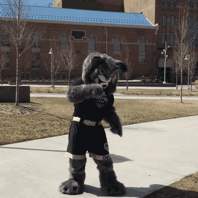 a mascot for the denver lions is standing in front of a building
