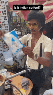 a man is holding a bag of cotton candy and asking if it is indian coffee .