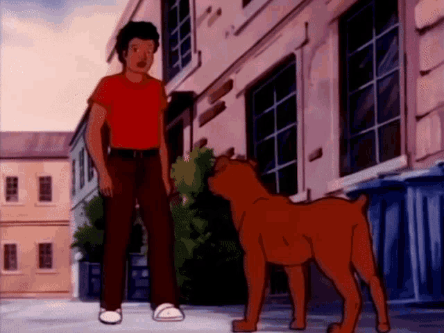 a man in a red shirt is standing next to a dog