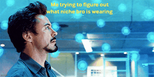 a man with a beard is looking up at something with the words me trying to figure out what niche bro is wearing above him