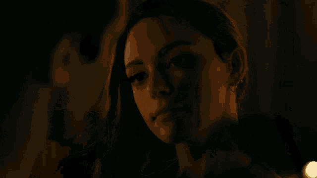 a couple kissing in a dark room with candles