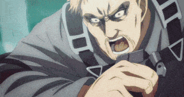 a close up of a man 's face with a triangle on his chest