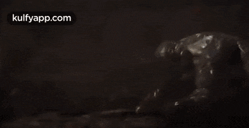 a close up of a person in a dark room with the words kulfyapp.com on the bottom .